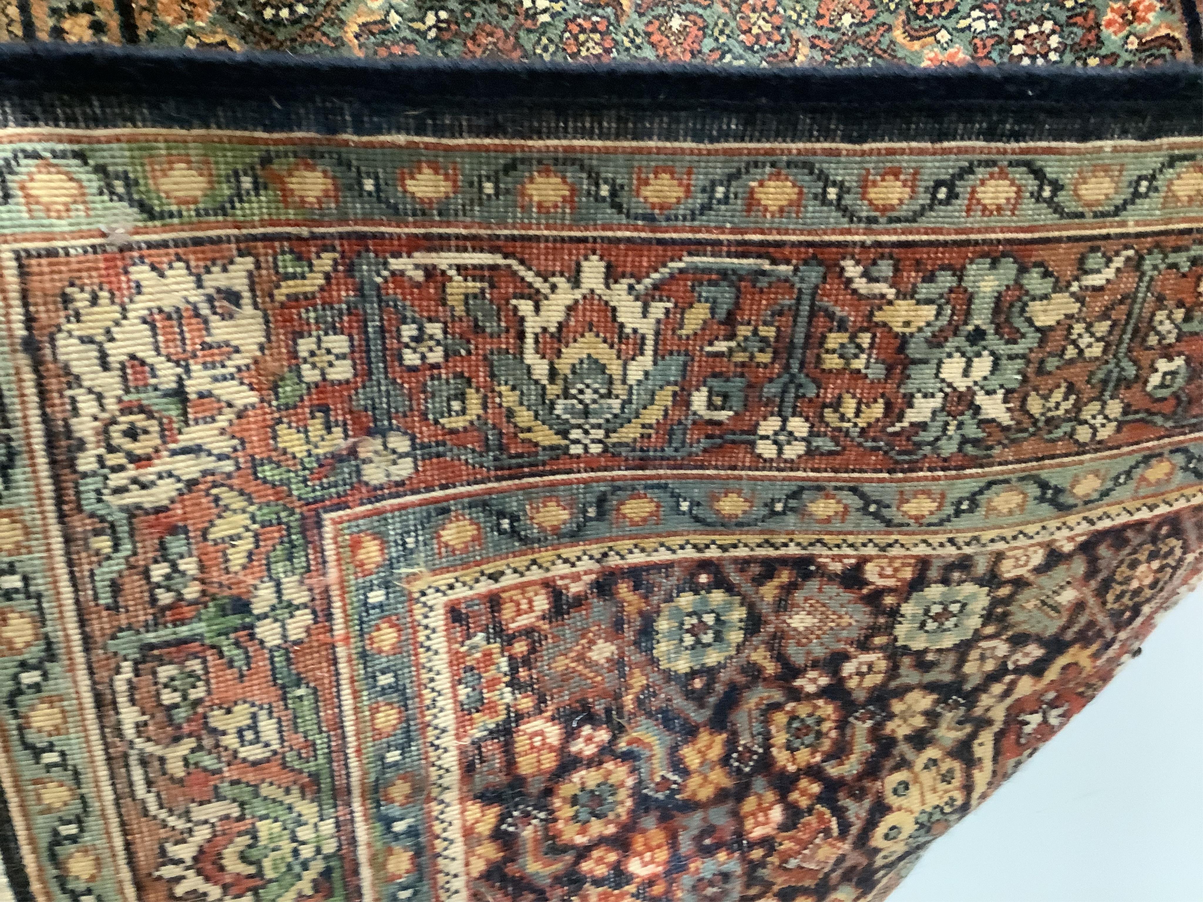 A Persian red and blue ground rug, 178 x 120cm. Condition - fair